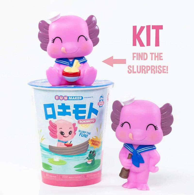 Chargez l&#39;image dans la visionneuse de la galerie, Pink toy figure with a blue bow tie in a container labeled &#39;Rokimoto&#39; on a white background.
